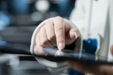 Close up of astronaut using tablet to verify mission parameters Stock Photos