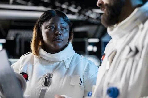 Close up of astronauts in spacecraft using laptop to track asteroids patterns Stock Photos