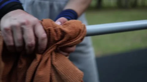 Close up of athlete hands gripping bar with fabric for better hold wearing wrist Stock Footage 316701066