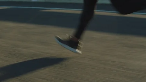 Close up athlete legs running on road fit runner jogging sprinting endurance Stock Footage