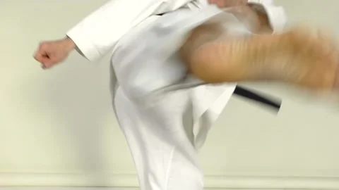Close-up of an athlete in motion performing punches and kicks Stock Footage 246981345