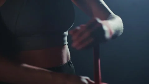 A close-up of an athlete preparing for training with wrist adjustments in a Stock Footage 285931346