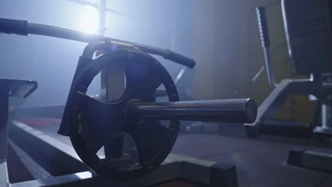 Close-up of athlete's hands putting weight on barbell in gym. Stock Footage 234423594