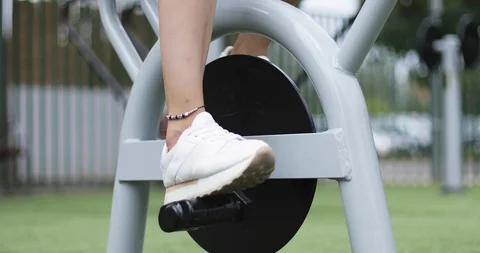 Close-up of athlete's legs on the simulator in the park. Stock Footage 103196851