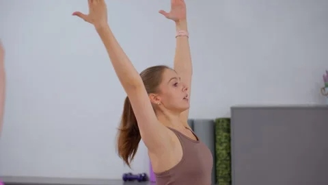 Close-Up of Athletes Synchronizing Arm Movements During Workout Stock Footage 304999438