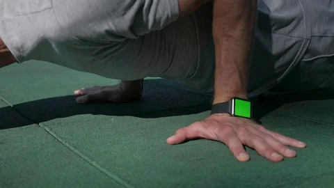 Close up of an athletic man doing push-ups wearing smart watch with green screen Stock Footage 94917203