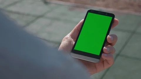 Close up of Athletic mans hands holding smartphone with green screen chroma key. Stock Footage 95232014