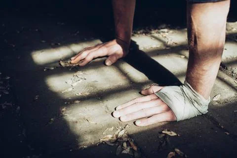 Close Up Of Athletic Young Man Hands While Exercise In Old Factory Building Foto stock