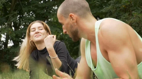 Close-up of athletic young people doing planks in public park in slow motion 스톡 동영상 114874276