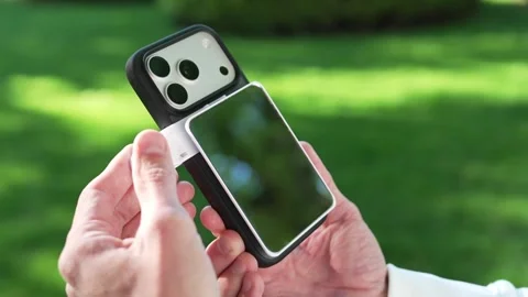 Close-up of Attaching Magnetic Smartphone Filter to Phone Case Видео 334615810