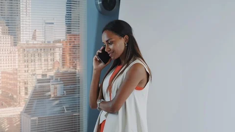 Close-up of attractive african model has stopped talking on smartphone and Video stock 122582389