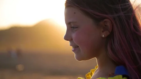 Close up of attractive and confident young girl standing on beach looking out Stock Footage 128599397