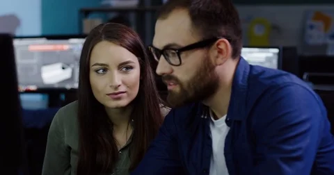 Close up of attractive couple of young office coworkers working successfully on Stock Footage 82447721
