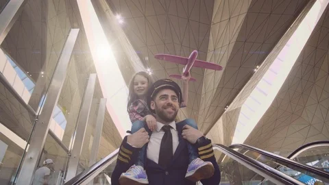 Close-up of attractive father pilot and little daughter ridding on his shoulders Stock Footage 109149641