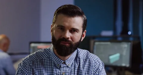 Close up of attractive man with a beard smiling into the camera sincerely on his Stock Footage 82474264