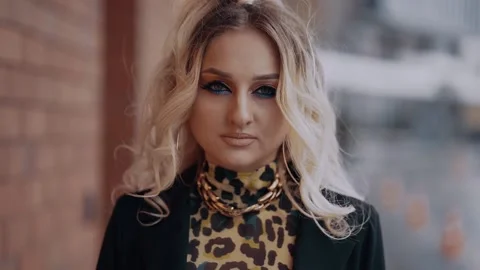 The close-up of an attractive professionally made-up blonde, whose hair is Stock Footage 157689351