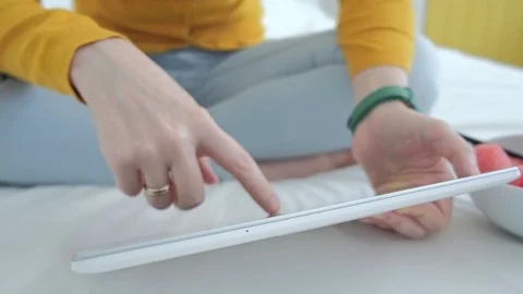 Close up of an attractive womans hands using tablet and zooming motions Stock Footage 94035680