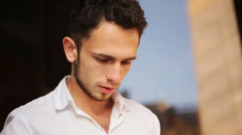 Close-up of attractive young male tapping his smartphone Stock Footage 59796607