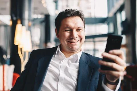 Close-up of attractive young man making a video call while sitting in a cafe  Stock Photos