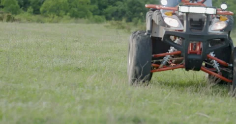 Close-up of an ATV speeding through the woods. The wheels of an ATV that goes Stock Footage 209997531