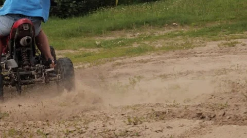 Close-up of ATV wheels kicking up dust and sand on a sharp turn. Slow motion Stock Footage 252086517
