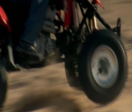 Close-up on ATV wheels through sand Stock Footage 21635030