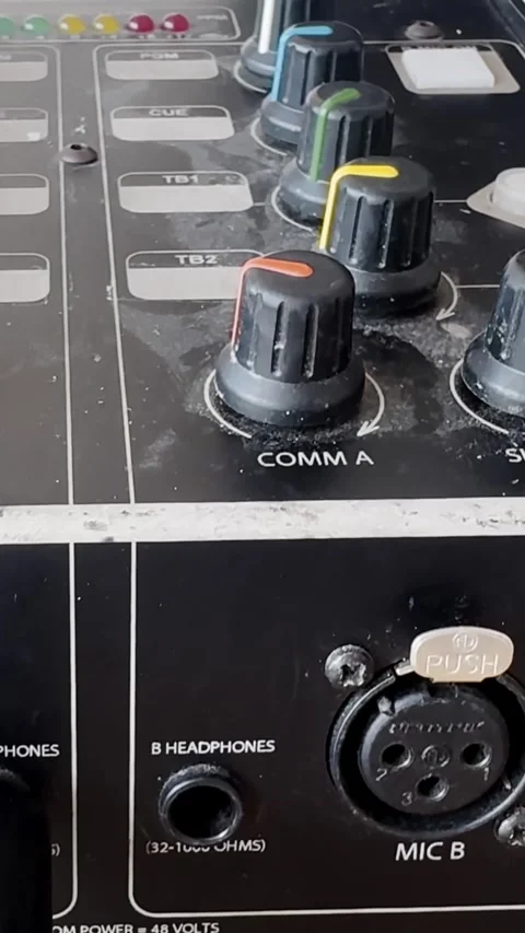 Close-up of an audio intercom panel with COMM A knob, MIC B XLR socket and Stockbeeldmateriaal 337231618