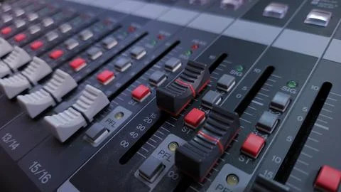 Close-up of an audio mixer with multiple control knobs for sound adjustments. Stock Photos