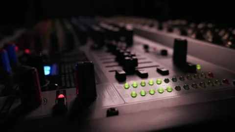 Close Up of Audio Mixing Console Faders and Green Led Lights in a Dark Studio Video stock 334739771