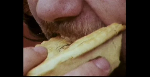 CLOSE UP OF AUSTRALIAN MAN EATING A MEAT PIE (1978) Stock Footage 263013453