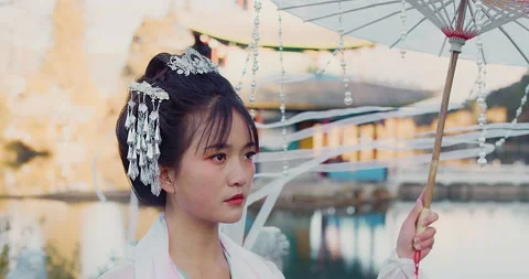 Close up of authentic beautiful young cultural Chinese woman walking with umbrel Video stock 201094343