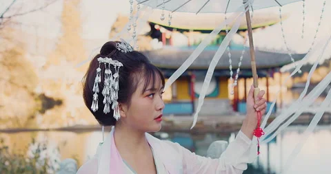 Close up of authentic beautiful young cultural Chinese woman walking with umbrel Stock Footage 201096143