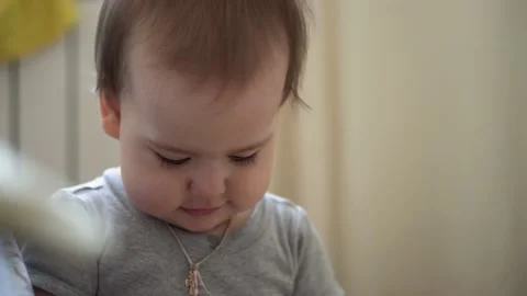Close up authentic cute infant chubby child girl with cross on chest make color Stock Footage 151928453