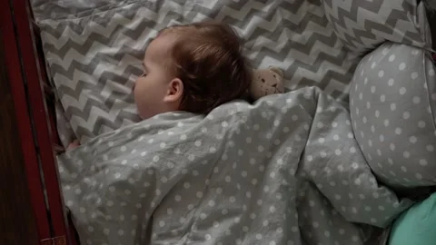 Close up authentic cute little infant chubby baby girl or boy sleep sweetly in Video stock 154533286