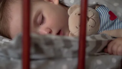 Close up authentic cute little infant chubby baby girl or boy sleep sweetly in Stock Footage 154613840