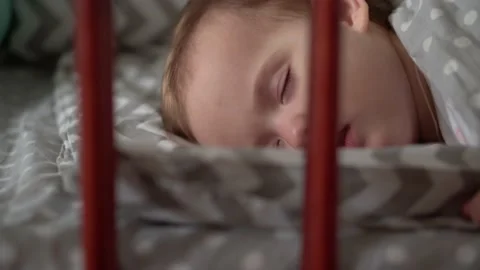 Close up authentic cute little infant chubby baby girl or boy sleep sweetly in Stock Footage 154841217