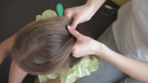 Close up authentic cute young caucasian woman mom caring for child braids Video stock 150047581
