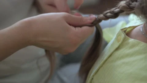 Close up authentic cute young caucasian woman mom caring for child braids Stock-Footage 150048016
