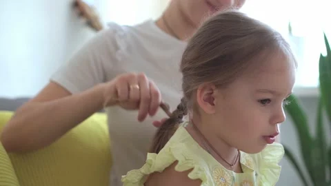 Close up authentic cute young caucasian woman mom caring for child braids Stock Footage 150068355