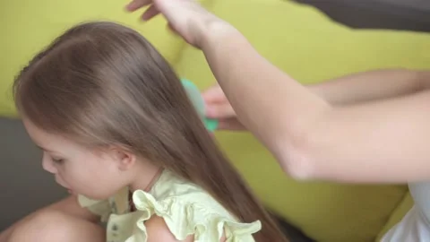 Close up authentic cute young caucasian woman mom caring for child braids Stock Footage 150186793