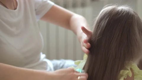 Close up authentic cute young caucasian woman mom caring for child braids Stock Footage 150237505