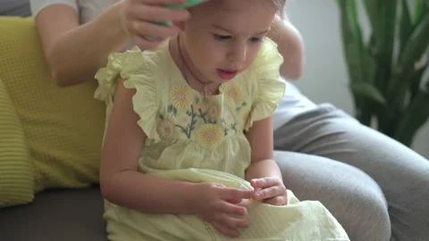 Close up authentic cute young caucasian woman mom caring for child braids Stock Footage 150237643
