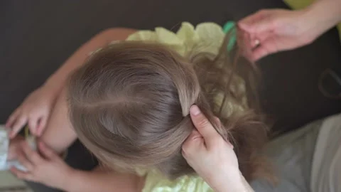 Close up authentic cute young caucasian woman mom caring for child braids Stock Footage 150282422