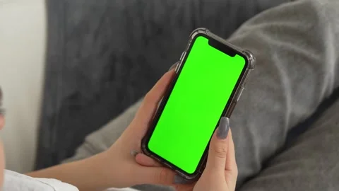Close Up of an Authentic Female Using Smartphone with Green Screen Mock Up Stock Footage 262077307