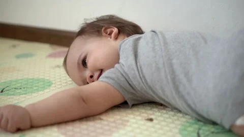 Close up authentic infant chubby child girl with cross on chest awkwardly walks Stock Footage 151752802