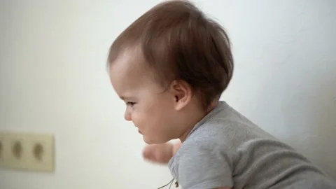 Close up authentic infant chubby child girl with cross on chest awkwardly walks Stock Footage 152265826