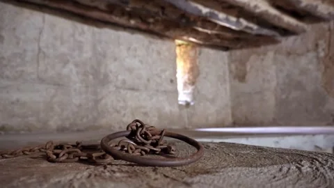 Close-up of authentic iron chains and shackles display in underground slave.. Stock Footage 331294867