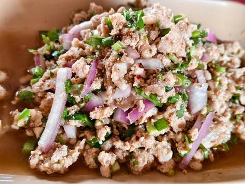 Close-up of authentic Thai Larb Moo (Spicy Minced Pork Salad) with ground r.. Stock Photos