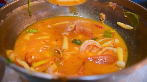 Close-up of authentic Thai Tom Yum Goong soup with shrimp, lemongrass, lime.. Stock Footage 318542332