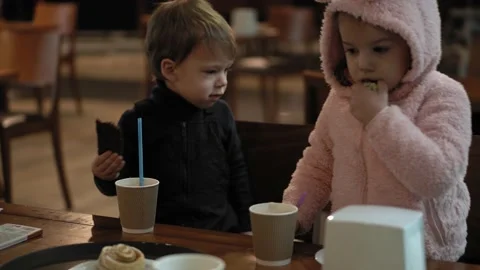Close-up of authentic two minor preschool siblings child boy and girl kids in a Stock Footage 148790430